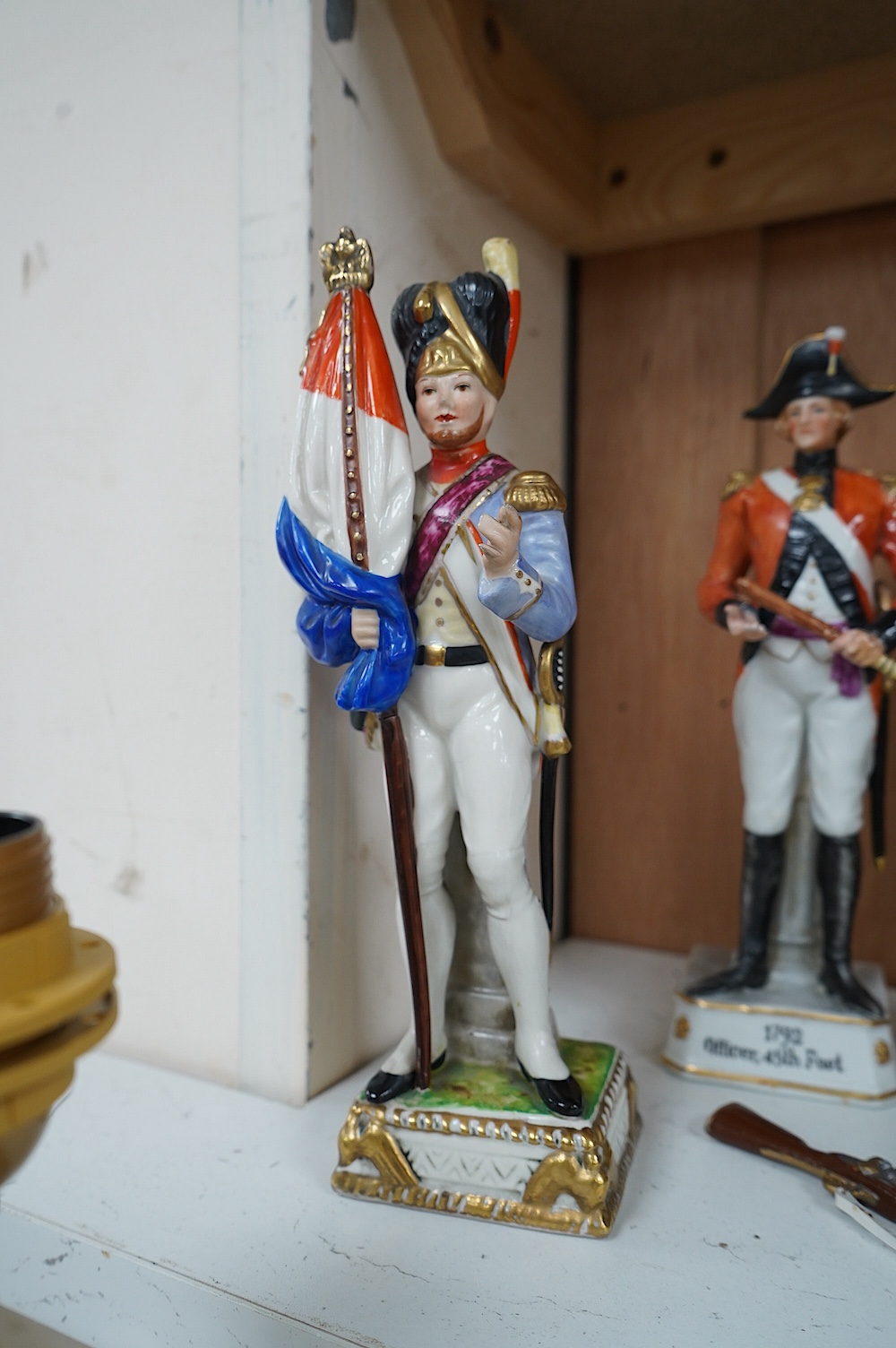 Four Continental porcelain figures wearing military dress including Napoleon and Officer, 45th Foot, largest 23cm high. Condition - good